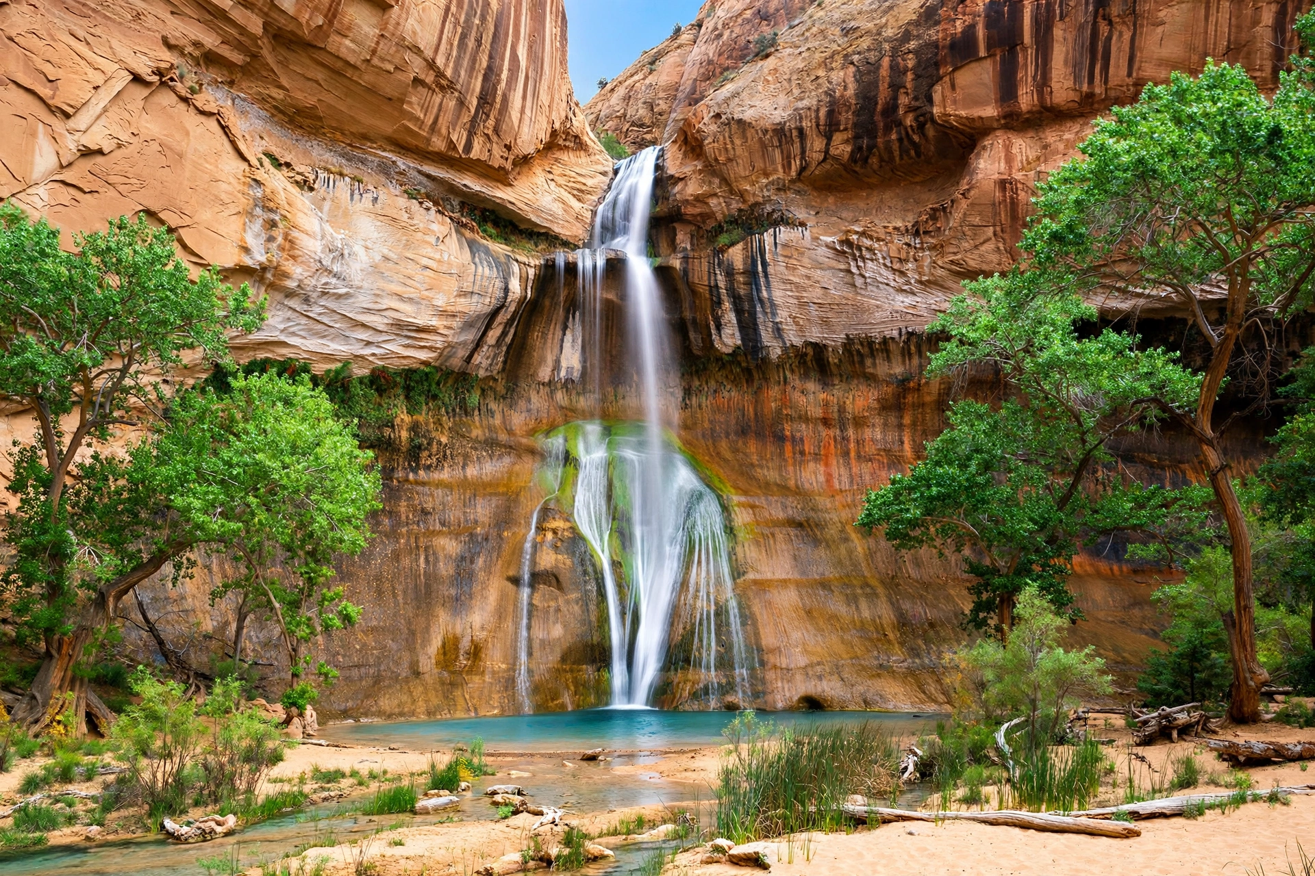 Grand Staircase-Escalante Camping 12 Lower Calf Creek Falls waterfall pouring into a turquoise pool in a red rock canyon